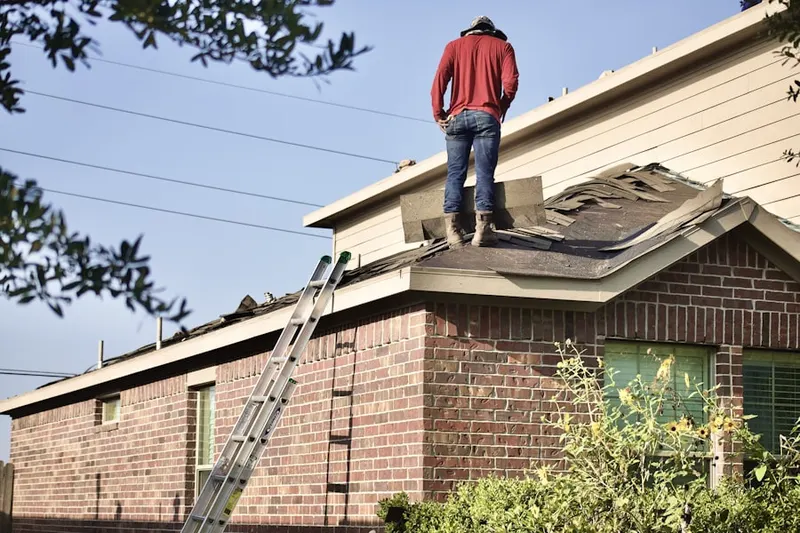 Professional roofer working on a residential roof in Ballast Point
